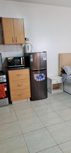 a kitchen with a stainless steel refrigerator in a room at Eagle nest 2 in Nairobi