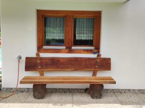 a wooden bench sitting in front of a window at Studio mit traumhafter Aussicht in Ritzingen