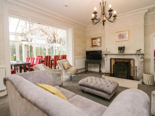 a living room with a couch and a fireplace at Valley View in Dalton in Furness