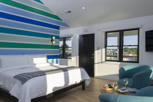 um quarto com uma cama e uma parede com riscas azuis e verdes em Inn at Haven Harbour em Rock Hall