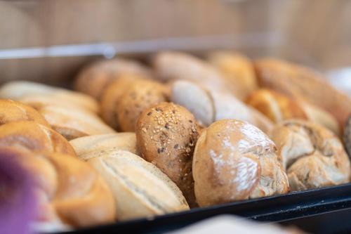 a bunch of different types of bread in a box at HOTEL MARIA in Gramatneusiedl