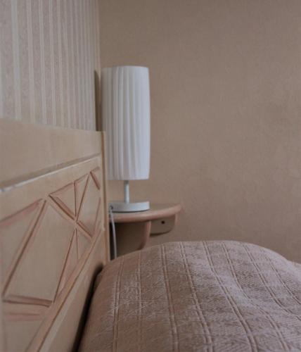 a bedroom with a bed and a table with a lamp at B&B La Gautraie in Carret