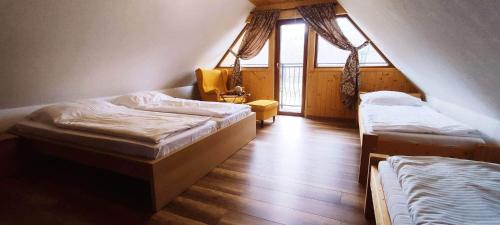 a room with two beds and a window at Chata pod kopcom in Žarnovica