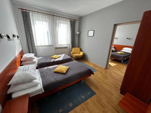 a hotel room with two beds and a mirror at Moto klub Brod in Slavonski Brod