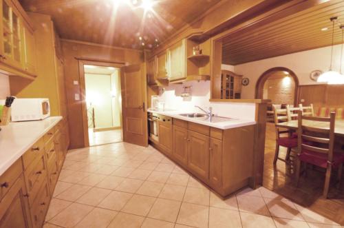 a kitchen with a sink and a table in a room at Chalet Lake View - Pinzgau Holidays in Zell am See