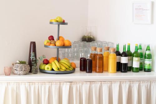 a shelf with a bunch of fruit and bottles of wine at HOTEL MARIA in Gramatneusiedl