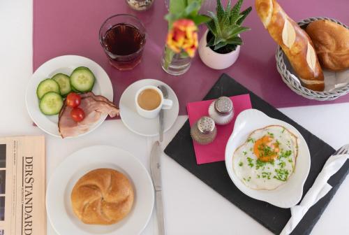 a table topped with plates of food and bread at HOTEL MARIA in Gramatneusiedl