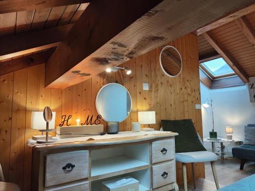 a bathroom with a vanity with a mirror on it at Charmant Duplex T3 avec Balcon - Halle Olympique in Albertville