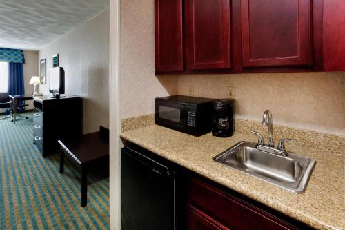 a kitchen with a sink and a microwave at Holiday Inn Express & Suites Smithfield - Providence, an IHG Hotel in Smithfield
