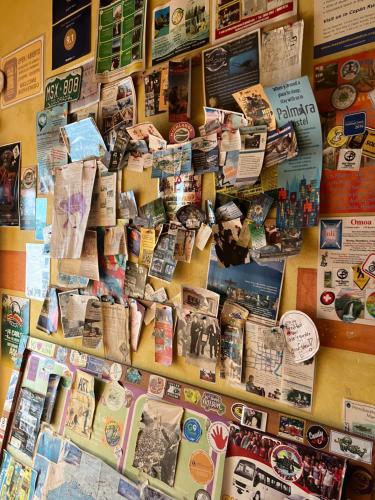 a wall filled with lots of signs and magnets at Hostel Iguana Azul in Copán Ruinas