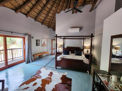 een slaapkamer met een bed in een kamer bij Milkwood Safari Lodge in Warmbaths