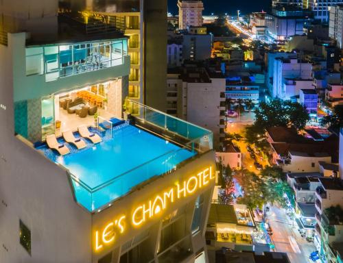a view of a hotel with a swimming pool at night at Le's Cham Hotel in Nha Trang