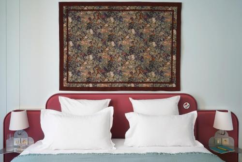 Ένα ή περισσότερα κρεβάτια σε δωμάτιο στο Hôtel Beauregard
