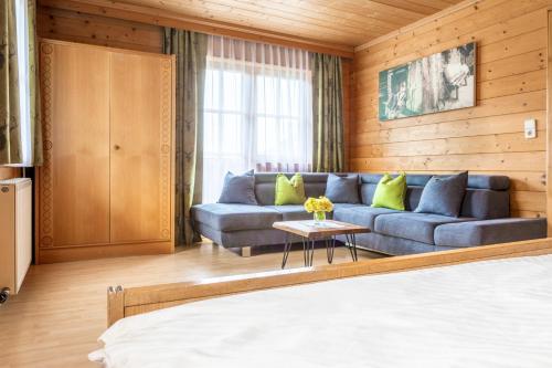 a living room with a couch and a table at Hallmoosgut in Sankt Johann im Pongau
