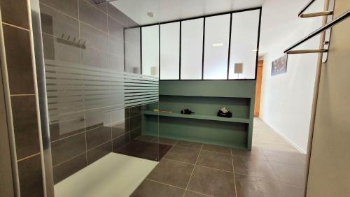 a bathroom with a shower with a glass door at Entre Ciel et Verdon in Castellane