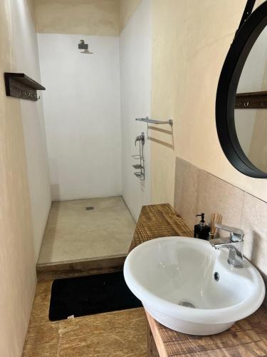 a bathroom with a white sink and a shower at Villa Keys in Wilderness