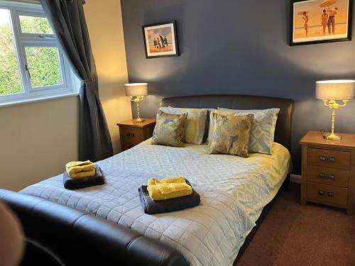 a bedroom with a bed with two towels on it at Ogilvie Lodge in Llandudno Junction
