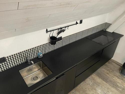 a kitchen counter top with a sink and a sink at Peter House in Nivelles