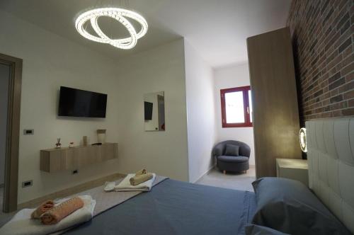 a bedroom with a blue bed and a chandelier at prima lux in Leverano