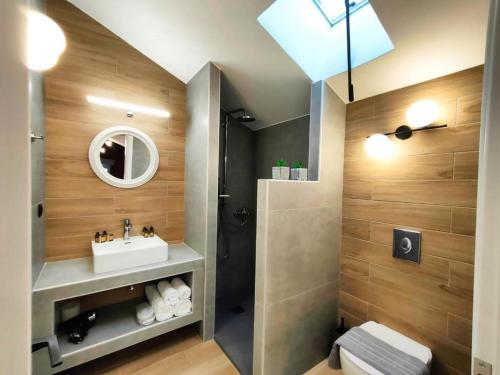 a bathroom with a sink and a shower at Centro Urban Suites in Kalabaka