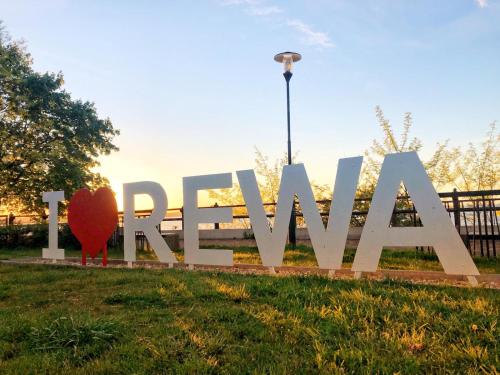 a large sign in the grass in a park at Willa Davia in Rewa