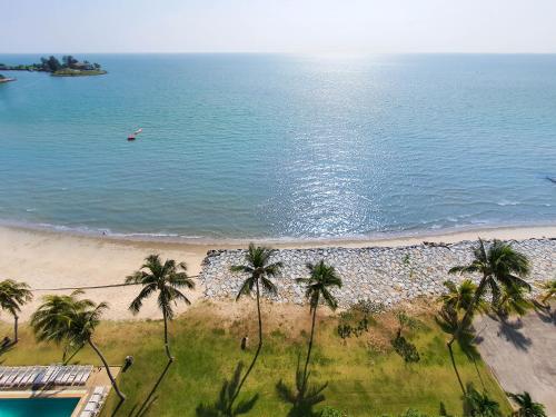 an aerial view of a beach with palm trees at 'Sunny Seaview' at Regency corner unit with 2 carpark by Shine Stay in Port Dickson