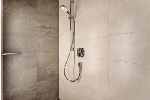a shower with a shower head in a bathroom at Luisalle Top 5 in Auffach