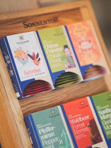 a group of books sitting on a shelf at Weingut & Gästehaus zum Seeblick - Familie Sattler in Jois