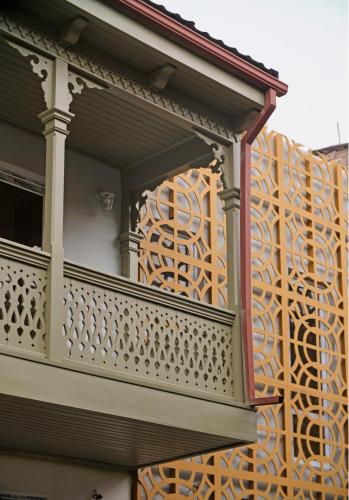 a balcony of a building with a wooden railing at Crystal Hotel Tbilisi in Tbilisi City