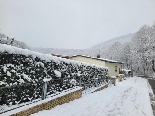 a fence covered in snow next to a house at Erholung Pur bei Nina in Bad Lauterberg