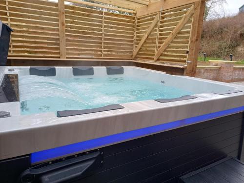 a large hot tub sitting on top of a patio at The Stables at Eriviat Hall in Henllan