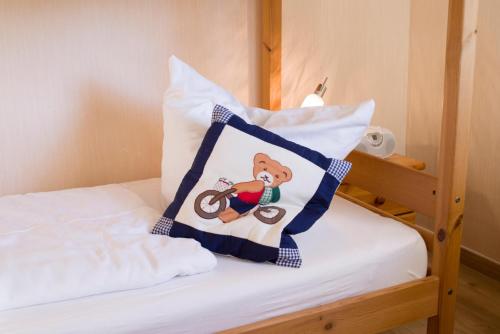 a bed with a pillow with a mickey on it at Apartmenthaus Frauenpreis FeWo 205 in Cuxhaven