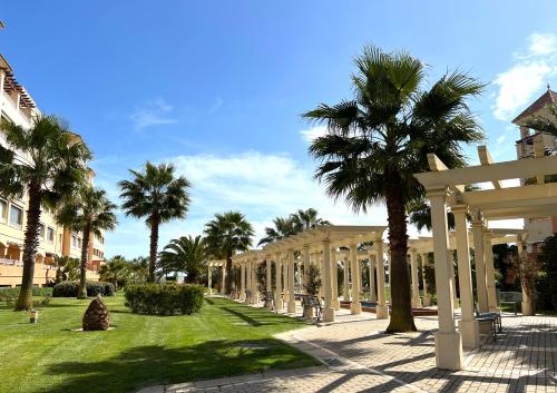 dziedziniec z palmami i budynek w obiekcie Ático de lujo - Luxury Penthouse w mieście Huelva