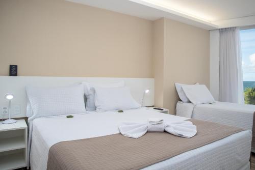 Ένα ή περισσότερα κρεβάτια σε δωμάτιο στο Hotel Brisa Suítes Pajuçara