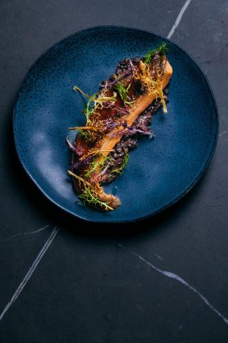 a blue plate with a piece of food on it at Hotel Gilbert in Vienna