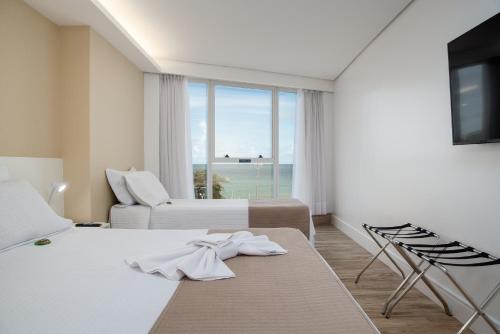 Ένα ή περισσότερα κρεβάτια σε δωμάτιο στο Hotel Brisa Suítes Pajuçara