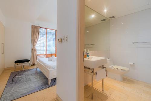 a white bathroom with a sink and a toilet at Park view Avalon Apartment District 1 HCM City in Ho Chi Minh City