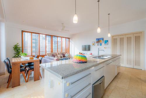 a kitchen with a kitchen island and a living room at Park view Avalon Apartment District 1 HCM City in Ho Chi Minh City