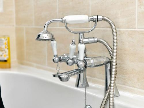 a sink with a faucet next to a bath tub at Westgate House in Cardiff