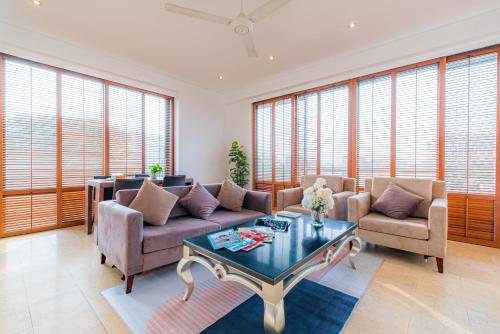 a living room with a couch and chairs and a table at Park view Avalon Apartment District 1 HCM City in Ho Chi Minh City