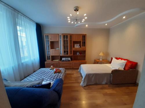 ein Wohnzimmer mit 2 Betten und einem Sofa darin in der Unterkunft Apartment Central Park in Daugavpils