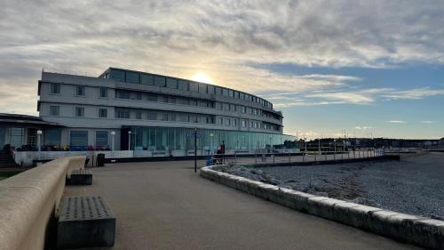 a building sitting next to a body of water at The Midland in Morecambe