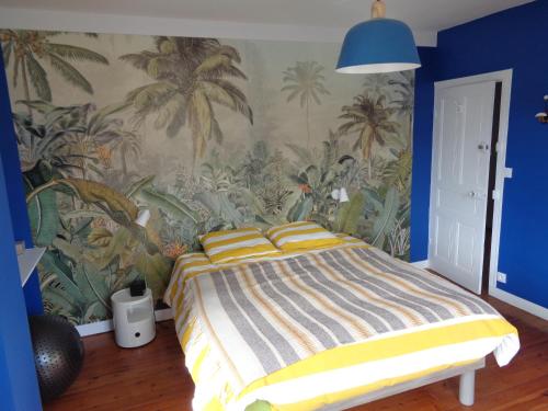 a bedroom with a bed with a tropical wallpaper at la maison blanche in Cléden-Cap-Sizun