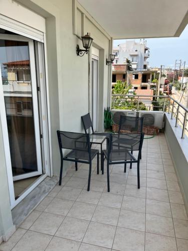 a patio with chairs and a table on a balcony at Christos in Rafina