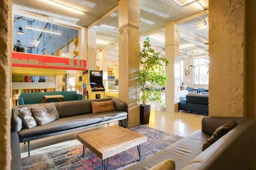 a living room with a couch and a coffee table at ClinkNOORD Hostel in Amsterdam