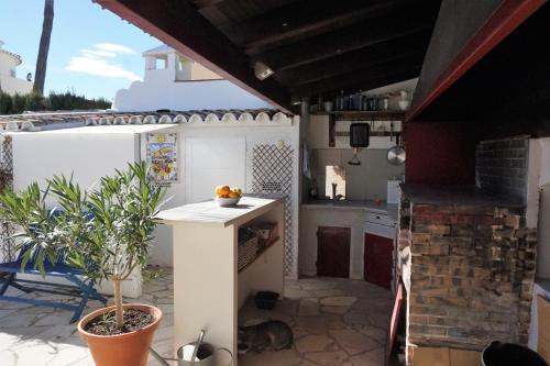 a kitchen with a counter and a table on a patio at Hana in Els Poblets