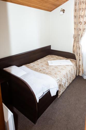 a small bed in a room with at Готель Скіфія in Lviv