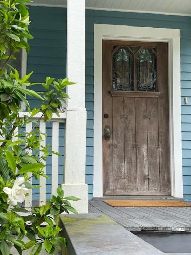 a blue house with a wooden door with a window at The Painted Lady, a spacious renovated 4BR Victorian in St. Augustine