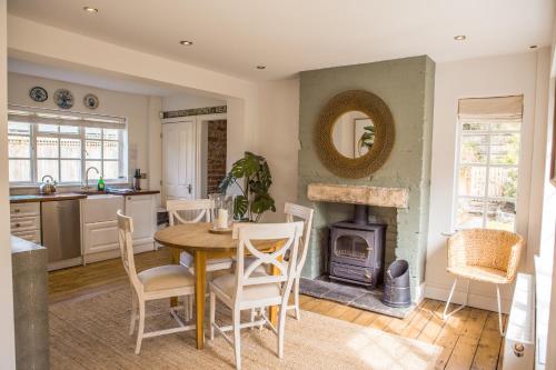 a kitchen with a table and a wood stove at Ribblesdale Park in Gisburn