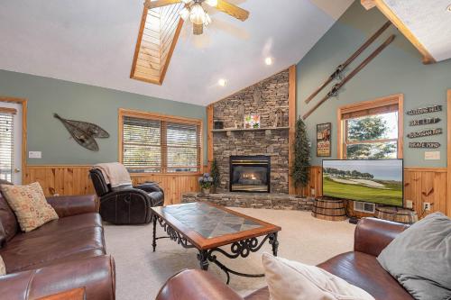 a living room with a fireplace and a tv at Fore Seasons Getaway in McHenry